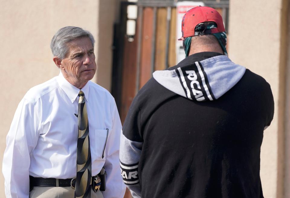 Arrowhead Precinct Constable Michael Branham listens to a tenant who has been evicted from their residence near downtown Phoenix on Oct. 20, 2021.