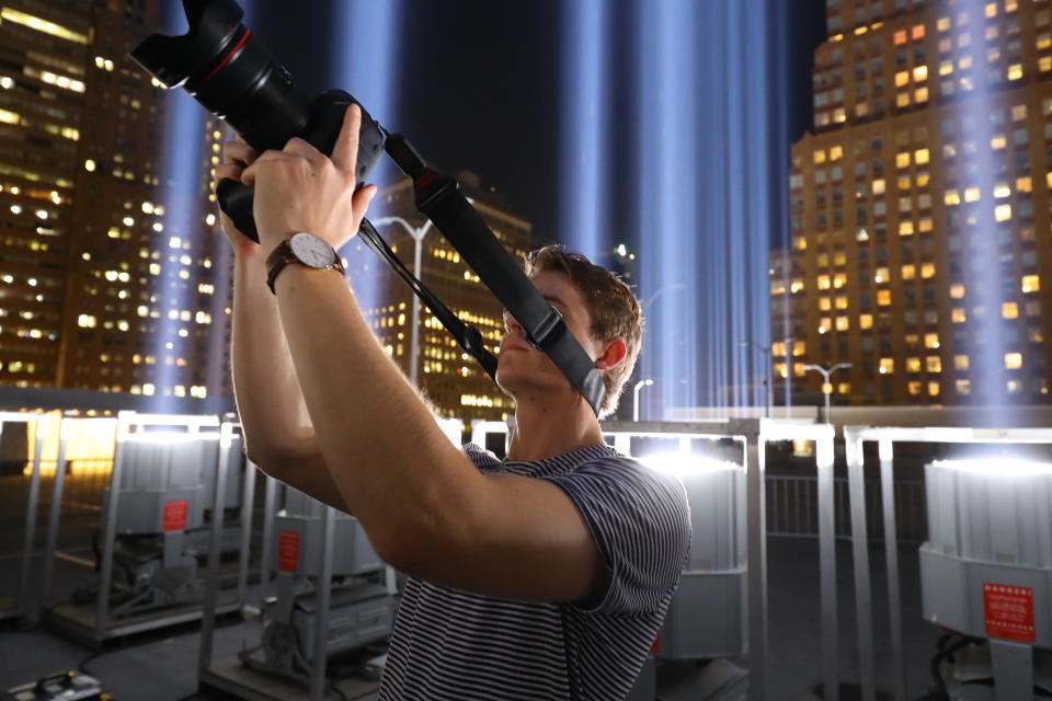 <p>A member of media takes a photo while attending a special viewing of the Tribute in Light on Sept. 5, 2018. (Photo: Gordon Donovan/Yahoo News) </p>