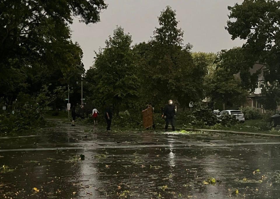 Storm debris covers West Washington Boulevard in Milwaukee on Sunday evening. A cluster of strong thunderstorms cut across central and southeastern Wisconsin.