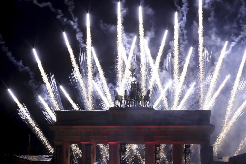 Fireworks light the sky during the New Year's celebrations at the Brandenburg Gate in Berlin, early Friday, Jan. 1, 2021. Germany is entering 2021 in a lockdown that appears certain to be extended beyond its current Jan. 10 end date, with new coronavirus cases and deaths related to COVID-19 remaining at worryingly high levels. (AP Photo/Michael Sohn)