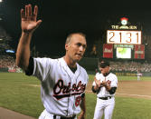 FILE - In this Sept. 6, 1995, file photo, Baltimore Orioles' Cal Ripken Jr. waves to the crowd as the sign in centerfield reads 2,131, signifying Ripken had broken Lou Gehrig's record of playing in 2,130 consecutive games, at Camden Yards in Baltimore. It has been 25 years since Ripken broke Gehrig's major league record for consecutive games played, a feat the Orioles star punctuated with an unforgettable lap around Camden Yards in the middle of his 2,131st successive start. (AP Photo/Denis Paquin, File)