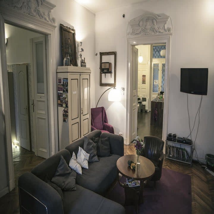 Living room with L-shaped couch, tv, and chairs