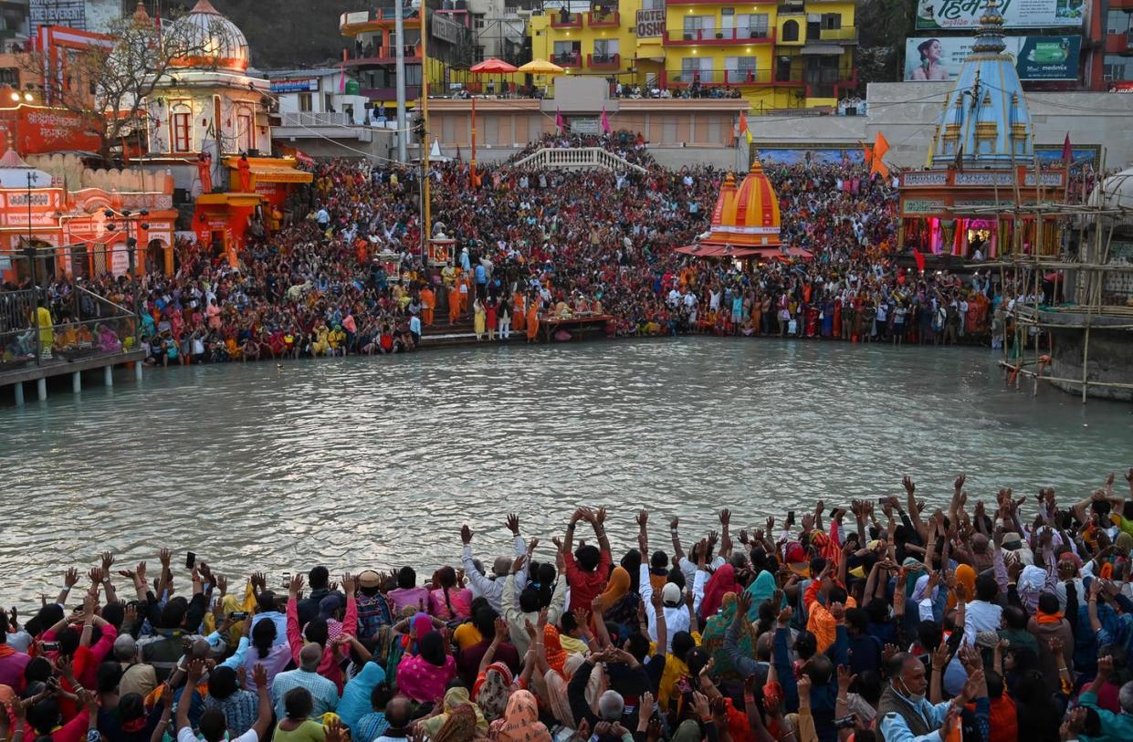 <span class="caption">Hindu devotees attend evening prayers on the banks of the Ganges River during the religious Kumbh Mela festival in Haridwar, India.</span> <span class="attribution"><a class="link " href="https://www.gettyimages.com/detail/news-photo/hindu-devotees-attend-evening-prayers-after-taking-a-holy-news-photo/1231647366?adppopup=true" rel="nofollow noopener" target="_blank" data-ylk="slk:Prakash Singh/AFP via Getty Images;elm:context_link;itc:0;sec:content-canvas">Prakash Singh/AFP via Getty Images</a></span>