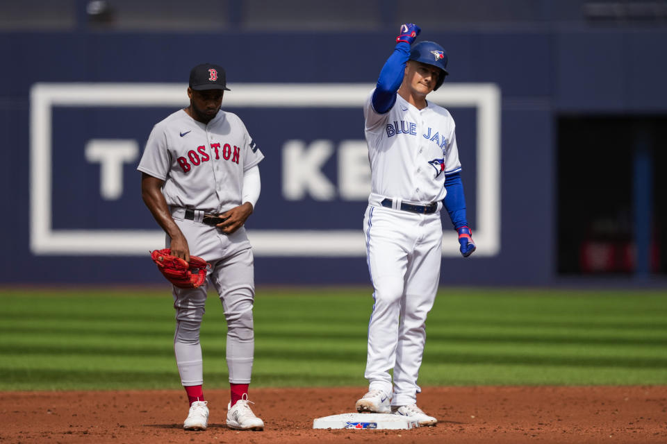 Toronto Blue Jays' Matt Chapman (26), right, celebrates a double against the Boston Red Sox during the second inning of a baseball game in Toronto, Sunday, Sept. 17, 2023. (Andrew Lahodynskyj/The Canadian Press via AP)