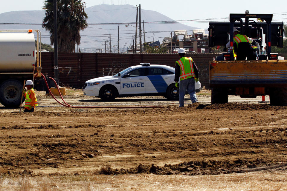 People work at the construction site of eight prototypes for President Donald Trump’s border wall with Mexico, in San Diego