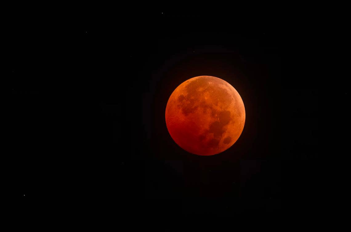 Former Kansas City Star photographer John Sleezer captured the total eclipse of the moon in the early morning hours of Tuesday, November 8, 2022 in Olathe, Kan. The next total lunar eclipse won’t be visible in this area until March 2025.