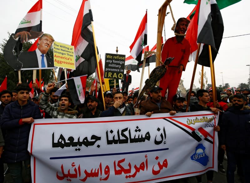 Supporters of Iraqi Shi'ite cleric Moqtada al-Sadr hold a sign reading "Our problems are all from America and Israel" at a protest against what they say is U.S. presence and violations in Iraq, in Baghdad