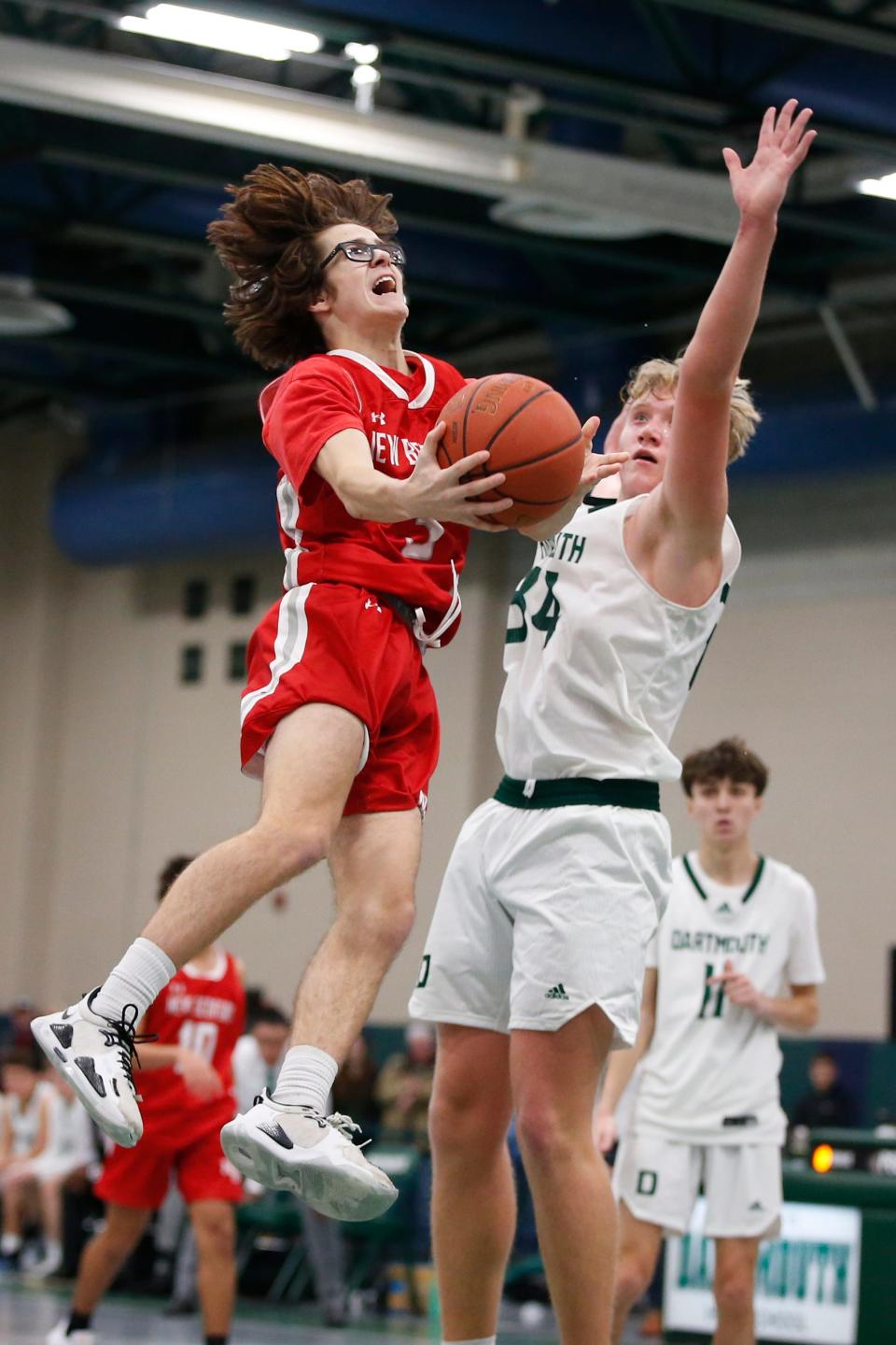 New Bedford's Craig Baptista goes up for the layup as Dartmouth's Hunter Matteson tries to block. Dartmouth High School boys basketball team beat New Bedford High School at home.