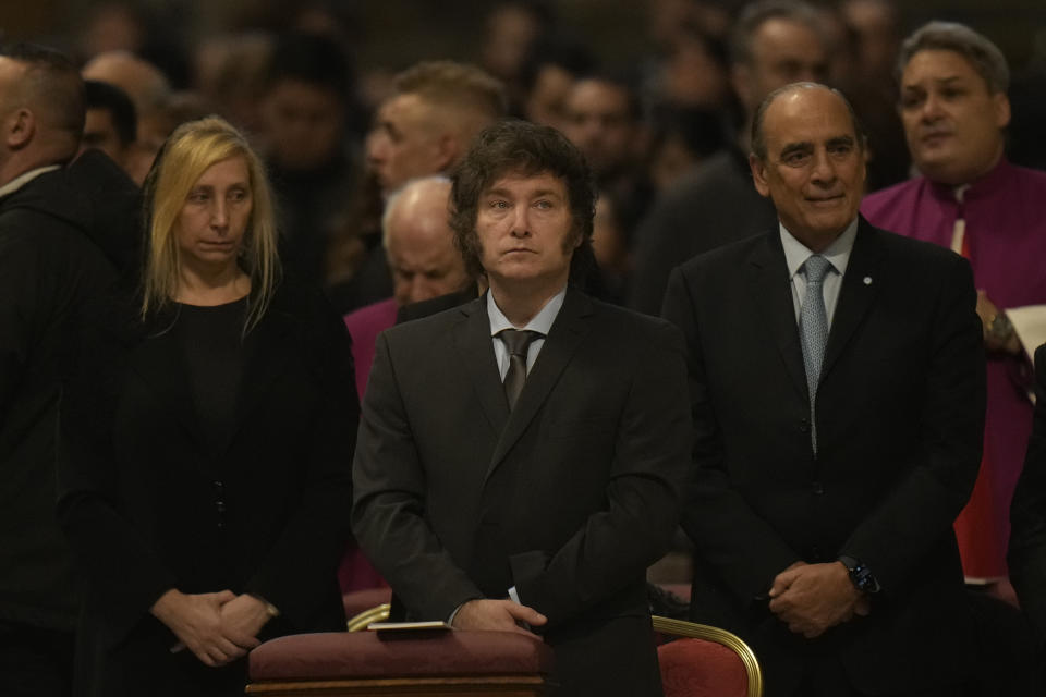 Argentine President Javier Milei, center, with his sister and Secretary-General of the Presidency Karina Milei, left, and Argentine Interior Minister Guillermo Francos attend in St. Peter's Basilica at The Vatican, Sunday, Feb. 11, 2024, the canonization of new Argentine Saint, María Antonia de Paz y Figueroa also known as "Mama Antula" presided over by Pope Francis. (AP Photo/Alessandra Tarantino)