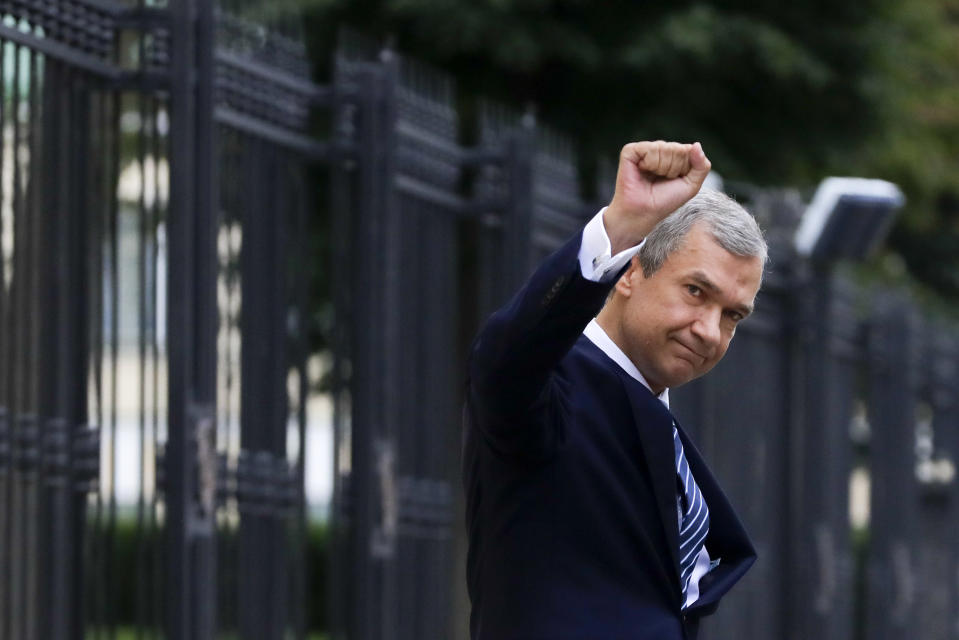 FILE - In this Aug. 25, 2020, file photo, Pavel Latushko, former culture minister and Belarusian ambassador to France, greets his supporters and journalists on his way to Belarusian Investigative Committee in Minsk, Belarus. Latushko, who joined the protesters, had his house splashed with red paint and received threats. "The authorities' scenario is clear: They are trying to stem the wave of protests by using force, slowing the processes and demotivating the leaders," he said. (AP Photo/Sergei Grits, File)