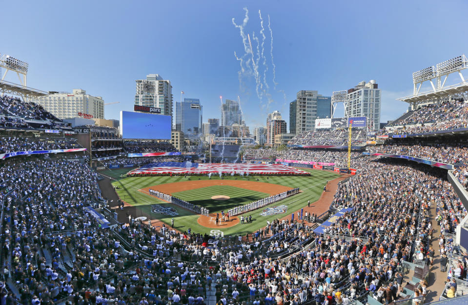 FILE - In this April 4, 2016, file photo, opening day ceremonies are performed at Petco Park before a baseball game between the Los Angeles Dodgers and the San Diego Padres in San Diego. California officials will allow people to attend Major League Baseball games and other sporting events, go to Disneyland and watch live performances in limited capacities starting April 1, 2021. The rules announced Friday, March 5, 2021, coincide with baseball's opening day. (AP Photo/Lenny Ignelzi, File)