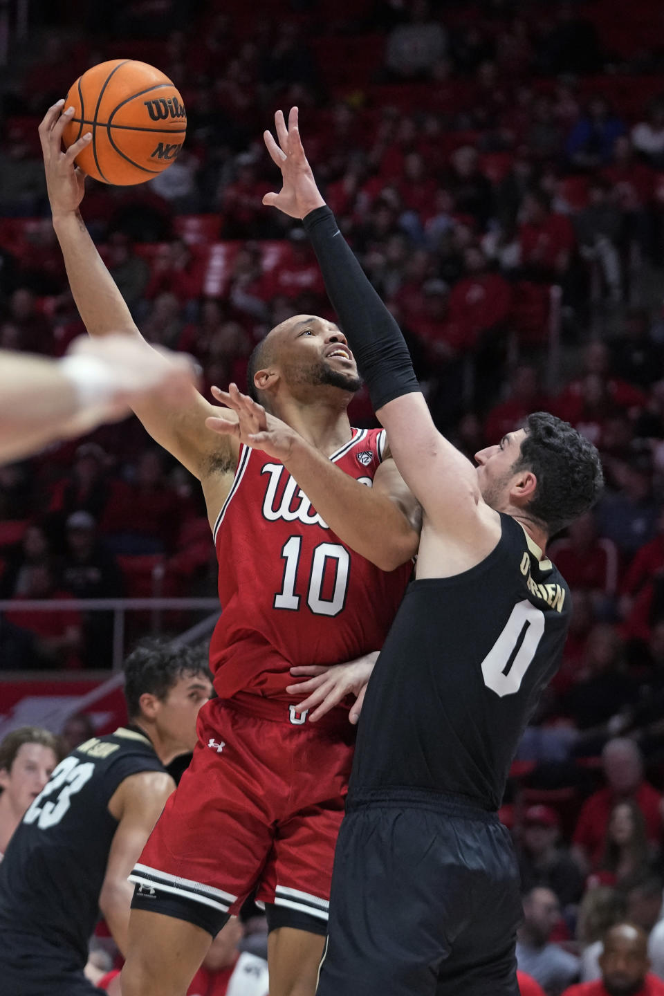 Utah guard Marco Anthony (10) shoots as Colorado guard Luke O'Brien (0) defends during the second half of an NCAA college basketball game Saturday, Feb. 11, 2023, in Salt Lake City. (AP Photo/Rick Bowmer)