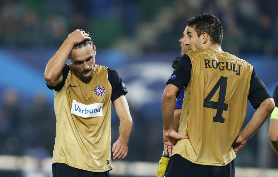 Austria Vienna's James Holland (L) and Kaja Rogulj react during their Champions League Group G soccer match against Atletico Madrid in Vienna October 22, 2013. REUTERS/Dominic Ebenbichler (AUSTRIA - Tags: SPORT SOCCER)