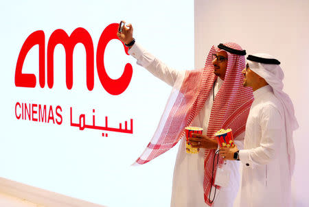 FILE PHOTO: Two Saudi men take a selfie at Saudi Arabia's first commercial movie theater in Riyadh, Saudi Arabia April 18, 2018. REUTERS/Faisal Al Nasser/File Photo