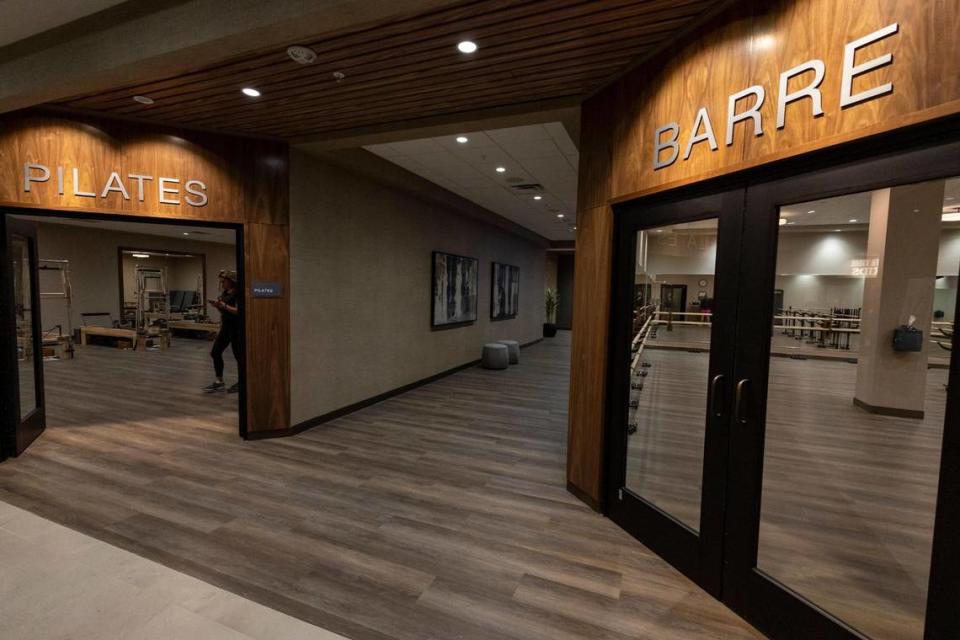 Adult members who plunk down $279 a month can swim laps in a saltwater pool, play pickleball, get a skin or nail treatment, hang at the beach club and eat breakfast or lunch at the cafe — and much more. Above: Pilates and Barre studios inside Life Time at The Falls.