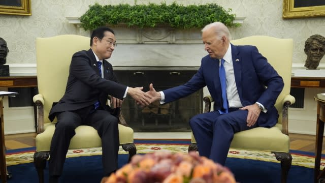 President Joe Biden and Japanese Prime Minister Fumio Kishida shake hands.