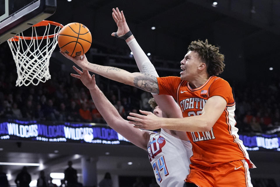 Illinois forward Coleman Hawkins, right, drives to the basket against Northwestern center Matthew Nicholson during the first half of an NCAA college basketball game in Evanston, Ill., Wednesday, Jan. 24, 2024. (AP Photo/Nam Y. Huh)