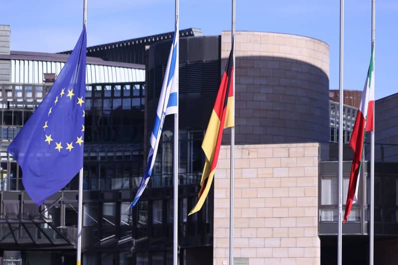 Flags in front of the North Rhine-Westphalian state parliament hang at half-mast on Holocaust Remembrance Day. David Young/dpa