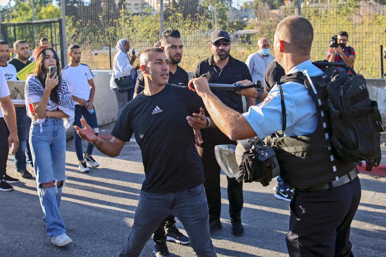 A Palestinian protester scuffles with a member of Israeli security forces near a roadblock at the entrance of the Sheikh Jarrah neighbourhood in east Jerusalem during a rally against the planned expulsion of Palestinians from houses there (AFP via Getty Images)