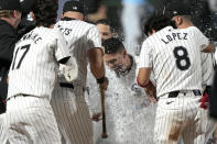 CORRECTS TO RAFAEL ORTEGA, INSTEAD OF ANDREW BENINTENDI - Chicago White Sox's Rafael Ortega, center, celebrates after scoring on Andrew Benintendi's game-winning, two-run home run off Tampa Bay Rays relief pitcher Phil Maton in the 10th inning of a baseball game Saturday, April 27, 2024, in Chicago. (AP Photo/Charles Rex Arbogast)