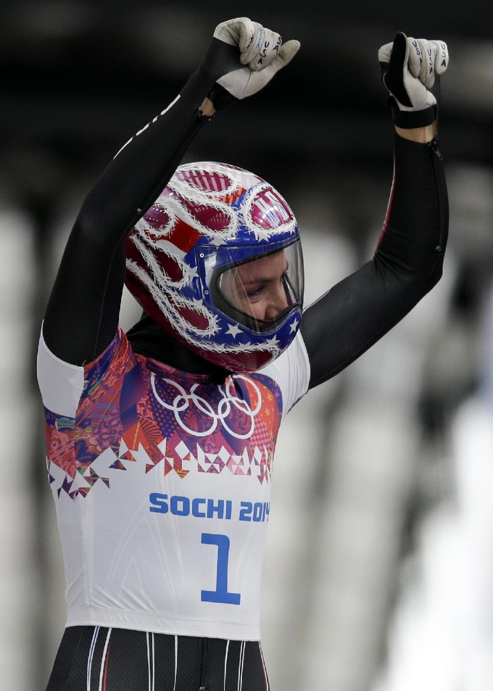 Noelle Pikus-Pace of the United States waves to supporters in the finish area after her first run during the women's skeleton competition at the 2014 Winter Olympics, Thursday, Feb. 13, 2014, in Krasnaya Polyana, Russia. (AP Photo/Natacha Pisarenko)