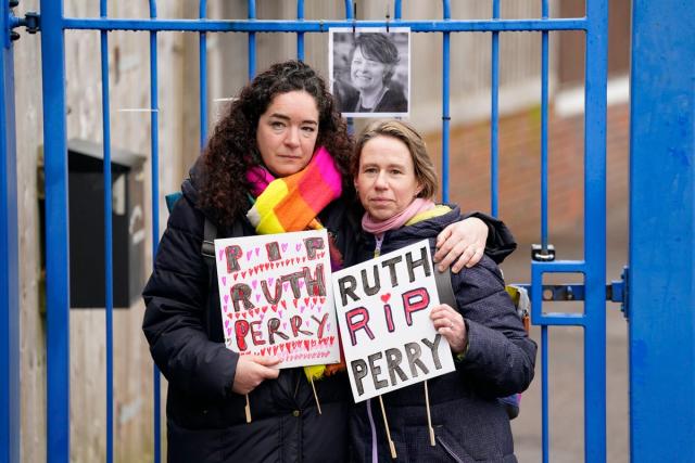 Two demonstrators mourn Ruth Perry outside the gates to John Rankin Schools in Newbury, Berkshire (PA)