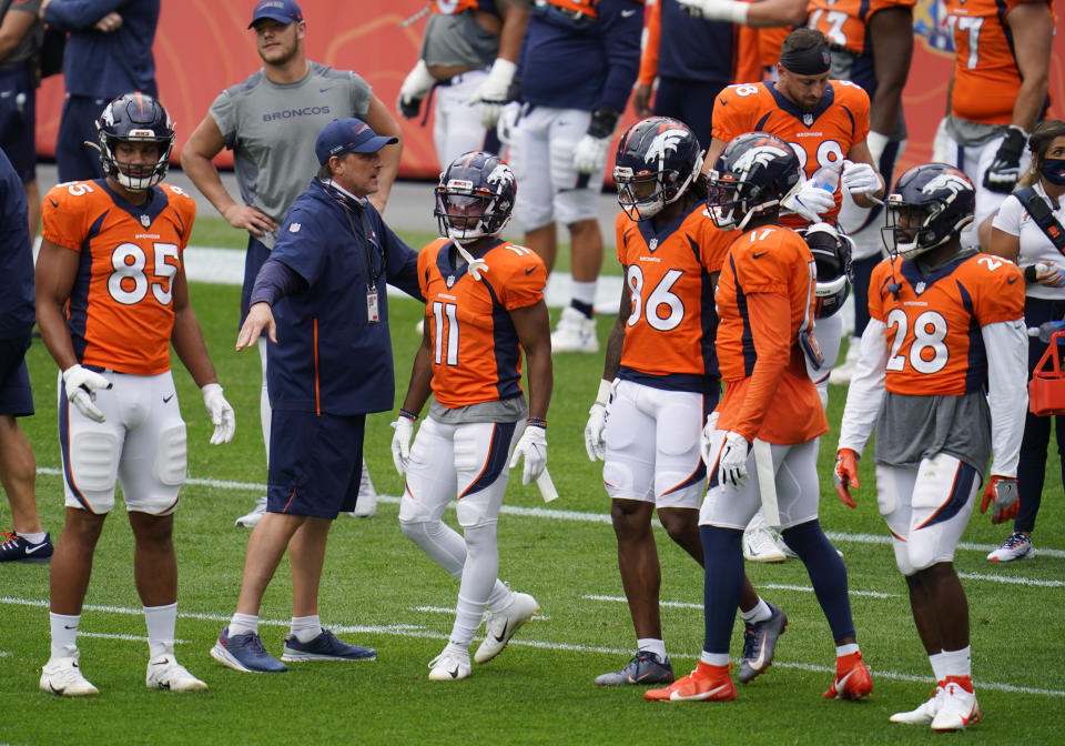 Denver Broncos quarterbacks coach Mike Shula, second from left, directs, from left to right, tight end Albert Okwuegbunam, wide receivers Diontae Spencer, Tyrie Cleveland and DaeSean Hamilton and running back Royce Freeman in a drill during an NFL football practice in empty Empower Field at Mile High, Saturday, Aug. 29, 2020, in Denver. (AP Photo/David Zalubowski)