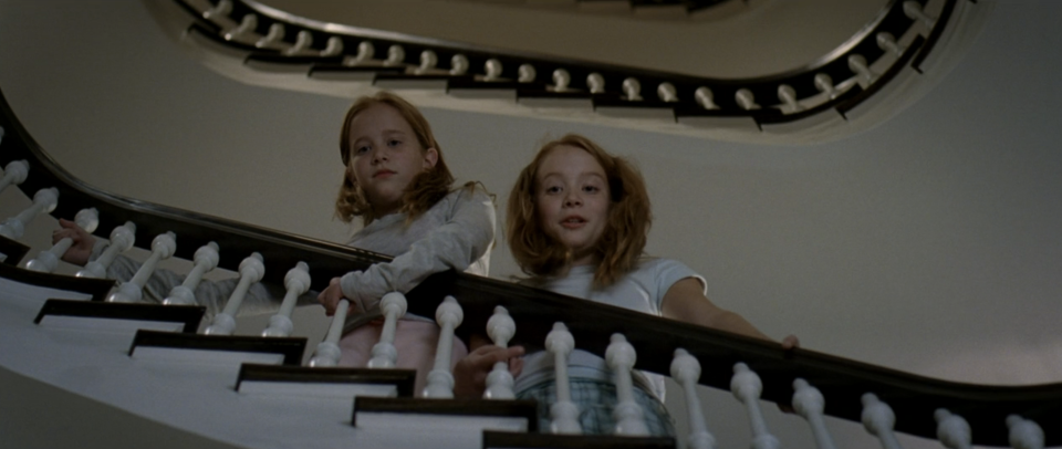 Miranda's twin daughters standing on the stairs