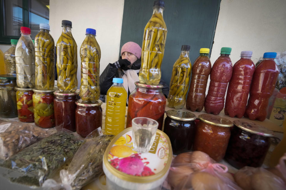 A woman sells home-grown produce in Comrat, Moldova, Saturday, March 12, 2022. Across the border from war-engulfed Ukraine, tiny, impoverished Moldova, an ex-Soviet republic now looking eagerly Westward, has watched with trepidation as the Russian invasion unfolds. In Gagauzia, a small, autonomous part of the country that's traditionally felt closer to the Kremlin than the West, people would normally back Russia, which they never wanted to leave when Moldova gained independence. (AP Photo/Sergei Grits)