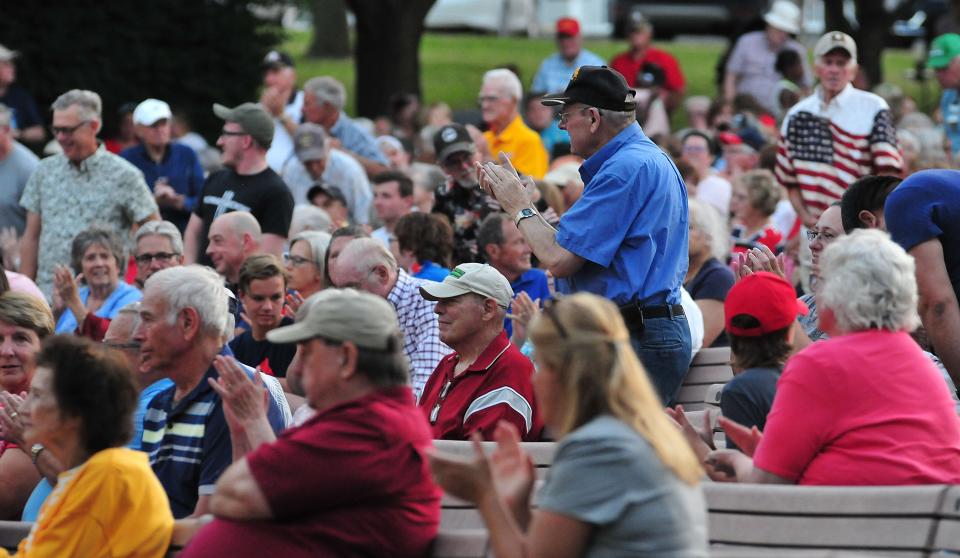 Veterans stand during the playing of the Armed Forces Salute at the Ashland Symphony Orchestra’s annual Pops in the Park Concert Sunday, July 3, 2022 at Guy C. Myers Memorial Bandshell, with new Conductor and Music Director Michael Repper leading the orchestra.
