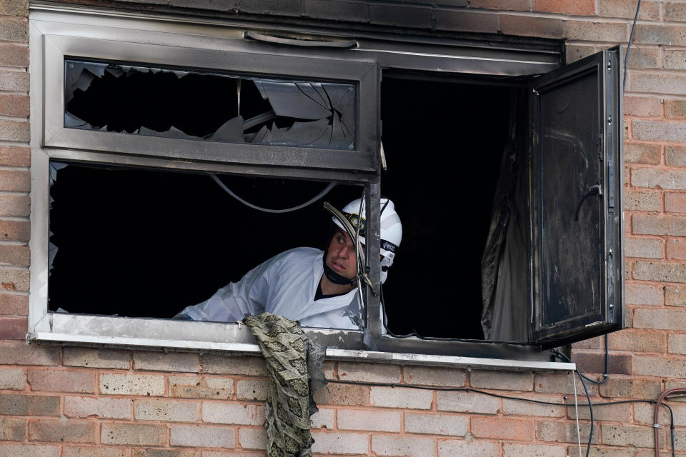 <p>Officers at a property on Tame Road in Tipton, West Midlands, where a house fire Tuesday evening has caused the death of a man and left a woman in hospital with smoke inhalation. An 18-year-old woman has been arrested on suspicion of arson. Picture date: Wednesday August 4, 2021.</p>
