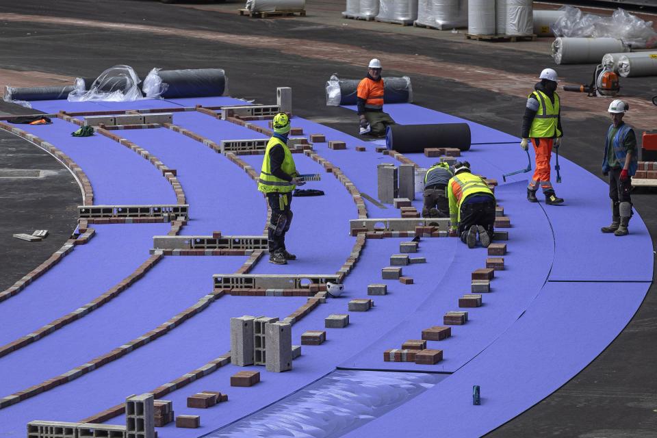 FILE - The athletics track at the Olympic Stadium, currently known as Stade de France, is installed, in Saint-Denis, north of Paris, April 9, 2024. (AP Photo/Aurelien Morissard, File)