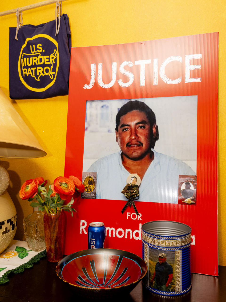 A placard stating “Justice for Raymond Mattia” propped up in the living room of his sister Annette Mattia’s house (Cassidy Araiza for NBC News)