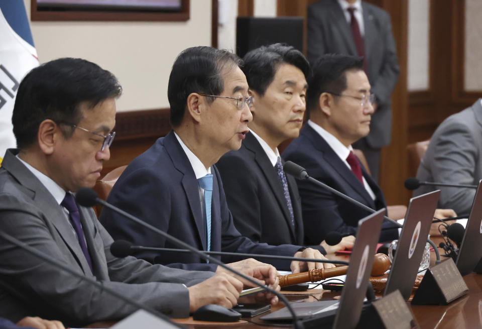 South Korea's Prime Minster Han Duck-soo, second left, speaks during a cabinet meeting at the government complex in Seoul, South Korea, Tuesday, June 4, 2024. South Korea’s government has approved the suspension of a contentious military agreement with North Korea, a step that would allow it to take tougher responses to North Korean provocations.(Choi Jae-gu/Yonhap via AP)