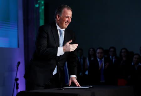 Mexican Finance Minister Jose Antonio Meade greets Claudia Pavlovich (not pictured), governor of Sonora state, during a women's empowerment event in Mexico City, Mexico, August 9, 2017. REUTERS/Ginnette Riquelme