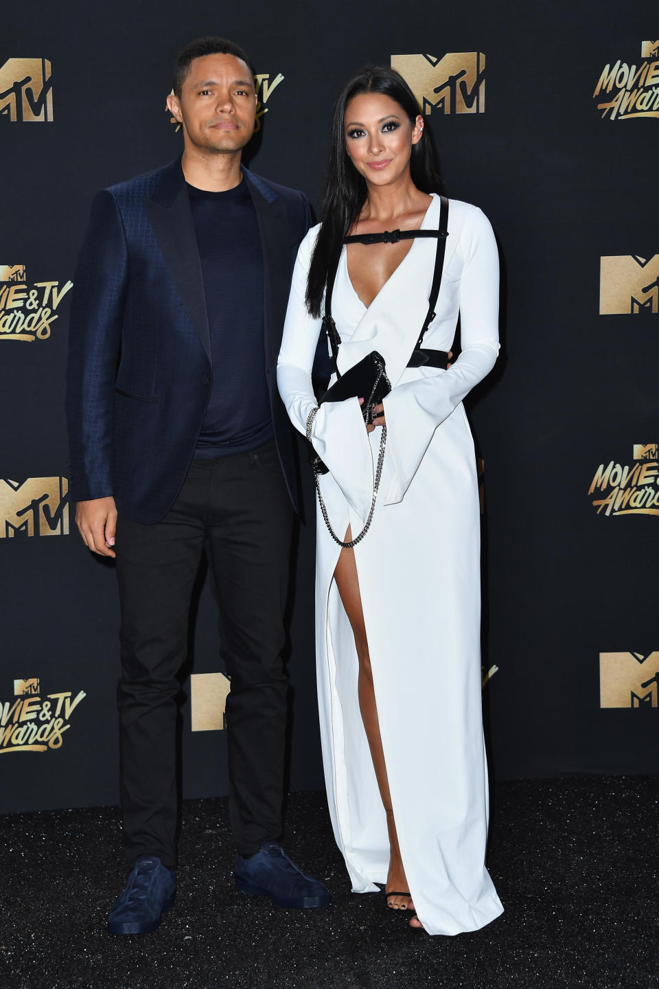 TV personality Trevor Noah (L) and singer Jordyn Taylor attend the 2017 MTV Movie and TV Awards at The Shrine Auditorium on May 7, 2017 in Los Angeles, California.&nbsp;