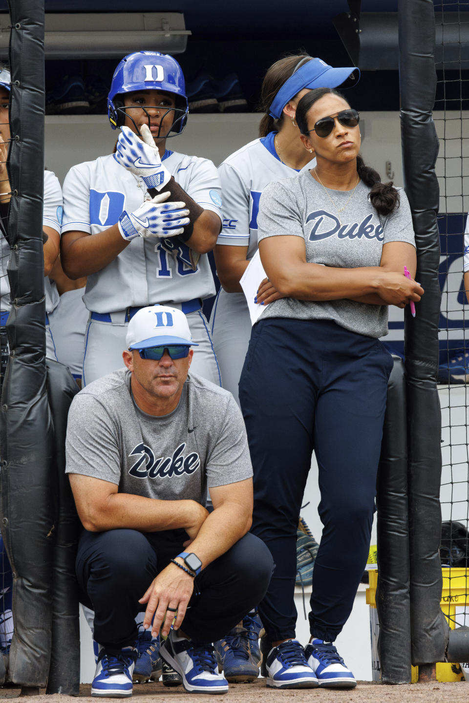 Duke head coach Marissa Young, right, Bryan Jones, front left, and D'Auna Jennings (10) look toward the field during an NCAA college softball game against Morgan State, Friday, May 17, 2024, in Durham, N.C. (AP Photo/Ben McKeown)
