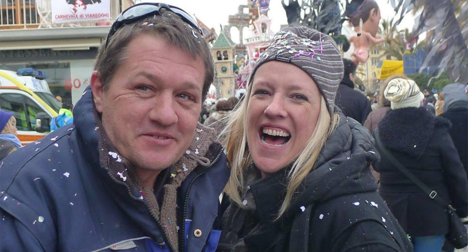 Ben and Rochelle Neill, both from New Zealand, smile while celebrating at a festival.