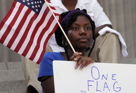Asha Jones listens to the speakers during a rally outside the State House to get the Confederate flag removed from the grounds in Columbia, South Carolina June 23, 2015. REUTERS/Brian Snyder