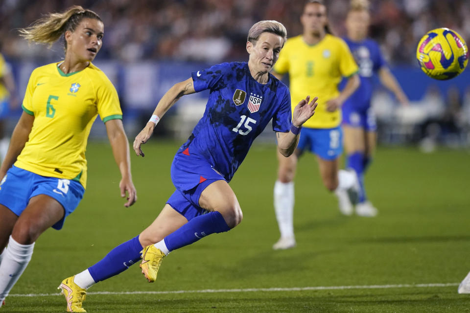 FILE - United States forward Megan Rapinoe (15) runs to the ball against Brazil defender Tamires (6) during the second half of a SheBelieves Cup soccer match Wednesday, Feb. 22, 2023, in Frisco, Texas. The United States won 2-0. (AP Photo/LM Otero, File)