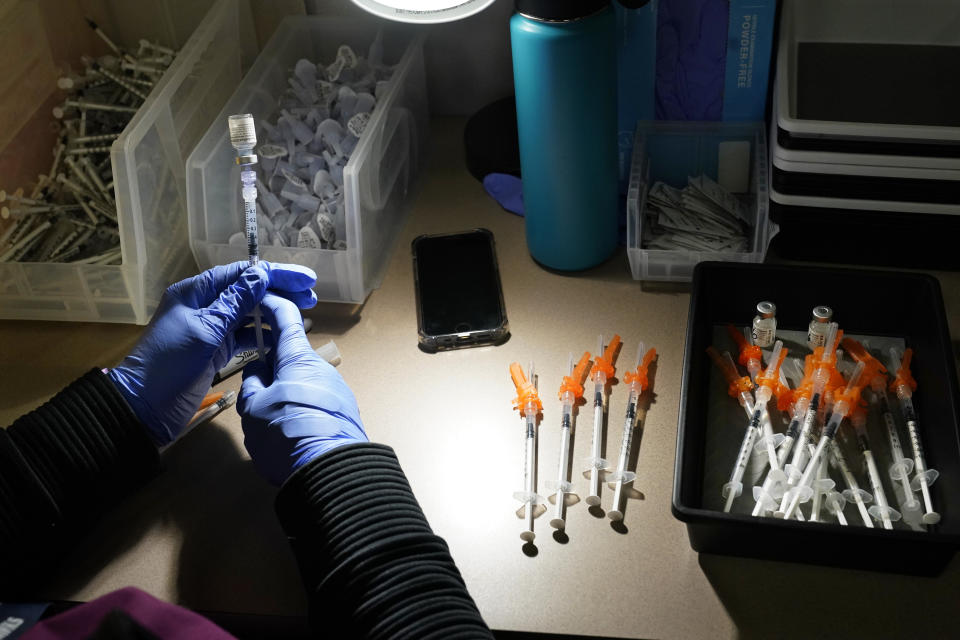 FILE - In this June 3, 2021, file photo, registered nurse fills syringes with Pfizer vaccines at a COVID-19 vaccination clinic at PeaceHealth St. Joseph Medical Center, in Bellingham, Wash. The latest alarming coronavirus variant, the delta variant, is exploiting low global vaccination rates and a rush to ease pandemic restrictions, adding new urgency to the drive to get more shots in arms and slow its supercharged spread. (AP Photo/Elaine Thompson, File)