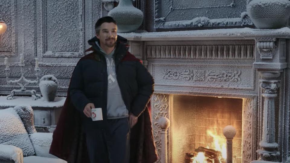 Doctor Strange in winter clothes stand in front of a fireplace with a coffee mugh inside a frozen, snow-covered Sanctum Santorum