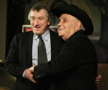 FILE - In this Jan. 27, 2005, file photo, Robert De Niro, left, and boxer Jake LaMotta stand for photographers before watching a 25th anniversary screening of the movie "Raging Bull," in New York. "Raging Bull," about the life of Jake Lamotta, was No. 7 in The Associated Press’ Top 25 favorite sports movies poll. (AP Photo/Julie Jacobson, File)