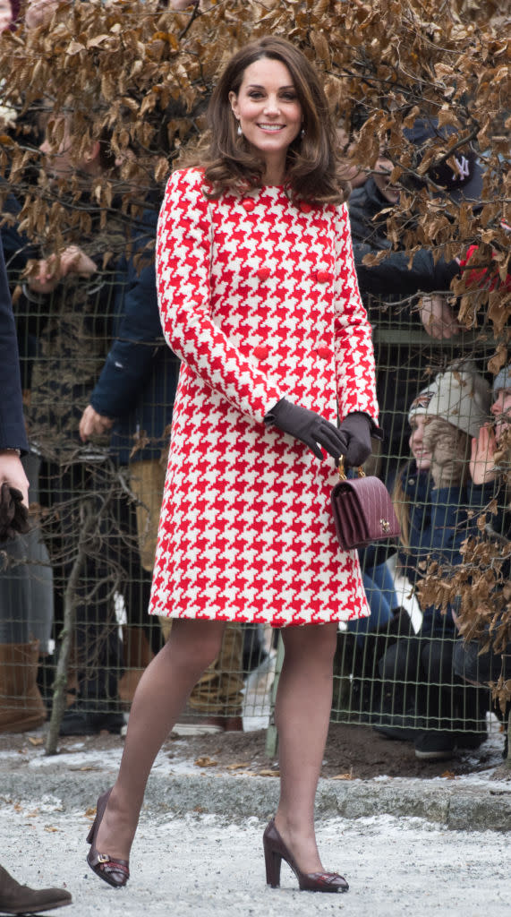 <p>To meet crowds in Stockholm, the pregnant royal donned a houndstooth-emblazoned dress by Alexander McQueen and her go-to Chanel Nouvelle Flap Bag (approx £3,500). <br>She accessorised the look with a pair of gloves by <a rel="nofollow noopener" href="https://www.corneliajames.com//products/imogen-merino-wool-gloves?variant=1777663427" target="_blank" data-ylk="slk:Cornelia James;elm:context_link;itc:0;sec:content-canvas" class="link ">Cornelia James</a> (£70), £107 <a rel="nofollow noopener" href="https://in2designing.com/collections/earring/products/baroque-ear-go-wh" target="_blank" data-ylk="slk:baroque earrings;elm:context_link;itc:0;sec:content-canvas" class="link ">baroque earrings</a> and Tod’s burgundy-hued block heels (£216). <em>[Photo: Getty]</em> </p>