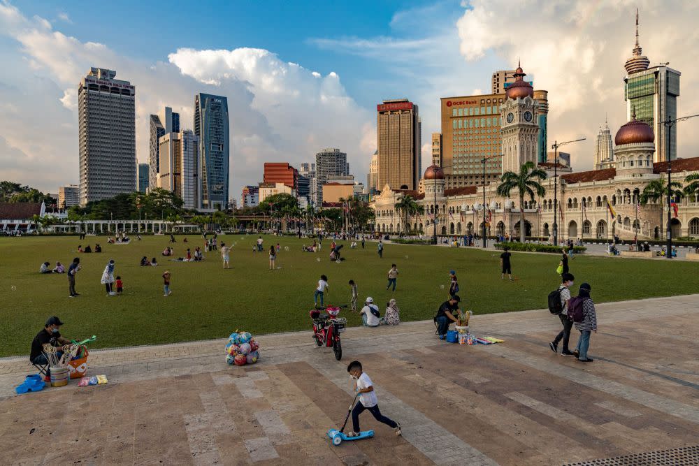 People enjoy an evening out at Dataran Merdeka in Kuala Lumpur. — Picture by Firdaus  Latif