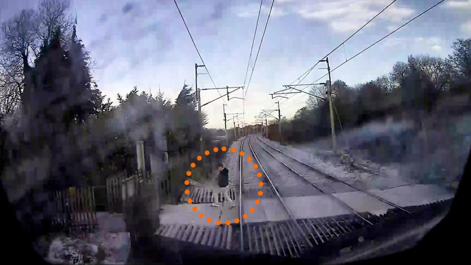 A pedestrian was just inches away from being hit by a speeding train in Runcorn, Cheshire. (SWNS)