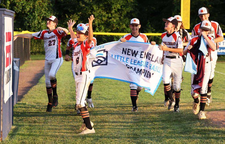 Middleboro 12U Nationals players celebrate with the New England banner at the conclusion of their game versus Bangor East, Maine at Bartlett Giamatti Little League Leadership Training Center in Bristol, Connecticut for the New England Regional tournament on Thursday, August 11, 2022.