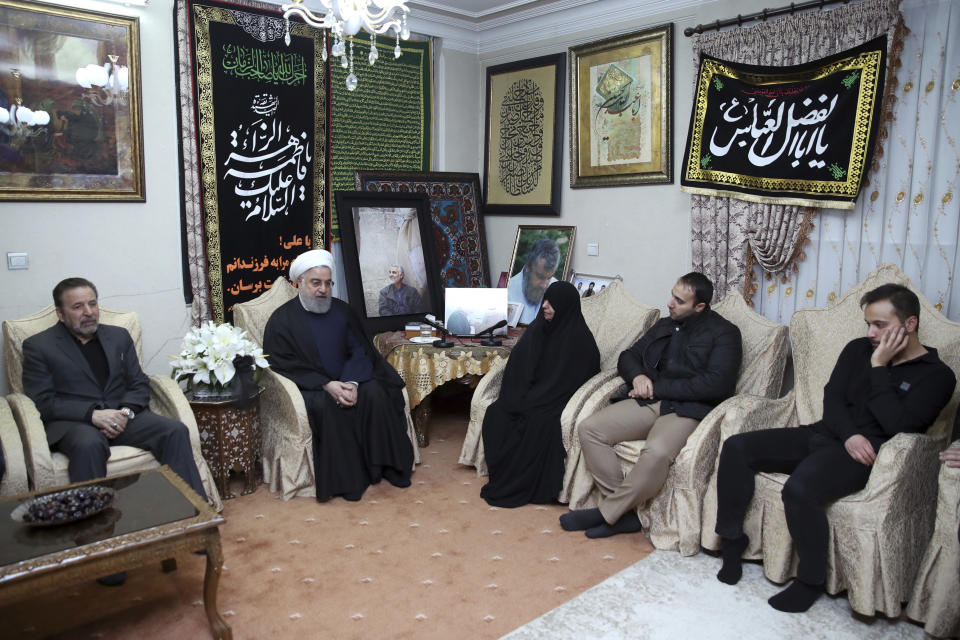 In this photo released by the official website of the office of the Iranian Presidency, President Hassan Rouhani, second left, meets family of Iranian Revolutionary Guard Gen. Qassem Soleimani, who was killed in the U.S. airstrike in Iraq, at his home in Tehran, Iran, Saturday, Jan. 4, 2020. (Iranian Presidency Office via AP)