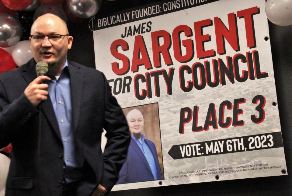 James Sargent speaks Saturday to supporters at his campaign launch event amid balloons and children playing in the gym behind him. He is seeking Place 3 on the council in his second bid for election. Jan. 28 2023