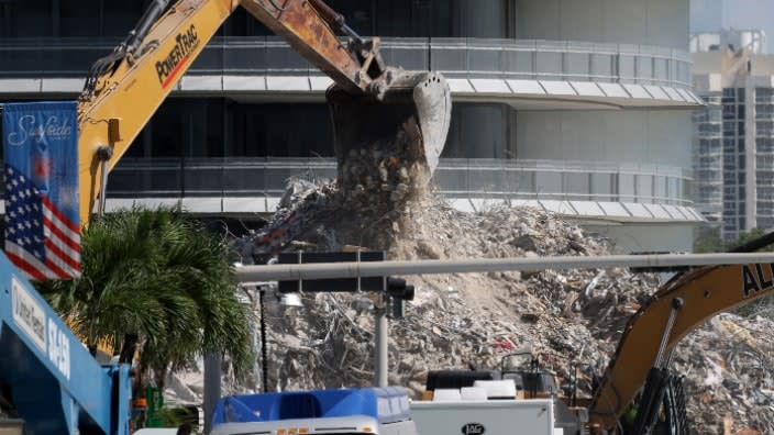 Construction equipment is used to dig through the mound of debris from the collapsed 12-story Champlain Towers South condo building last month in Surfside, Florida. (Photo by Anna Moneymaker/Getty Images)